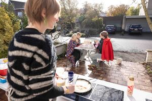 Mevrouw bakt pannenkoeken, kinderen smullen